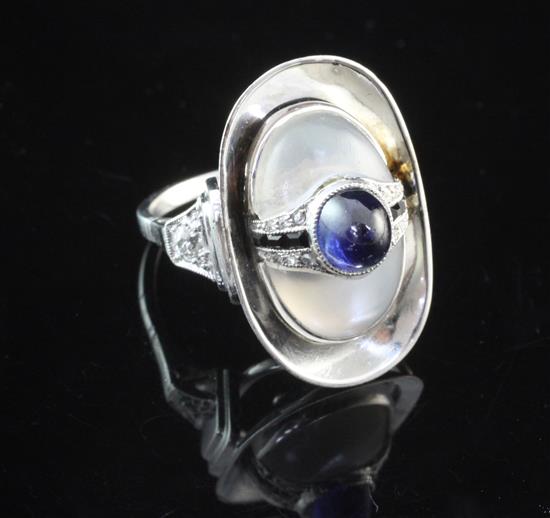 A stylish 14ct white gold, rock crystal, diamond and cabochon sapphire set dress ring, size M.